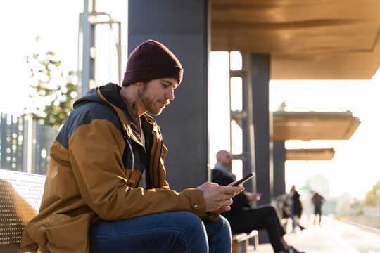 Man using phone at train station