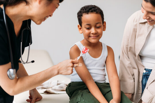 Doctor Giving Lollipop to Little Boy