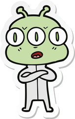 sticker of a cartoon three eyed alien