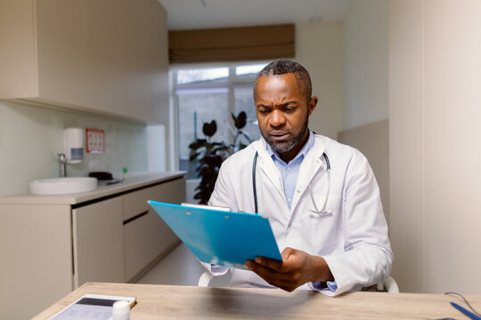 Doctor review clipboard facial expression healthcare facility 