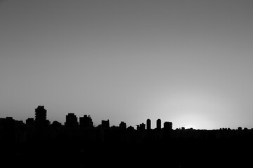 Sao Paulo city skyline during a sunset in summer photographed in black and white