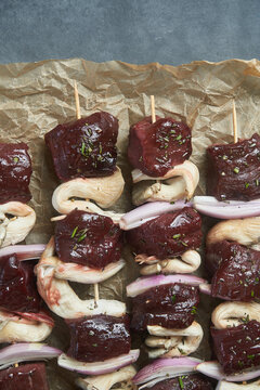 Skewers of raw beef and mushroom chunks