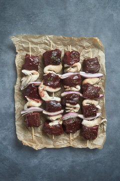 Skewers of raw beef and mushroom chunks