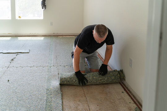 Man removing old carpet pad