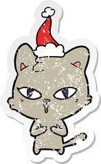distressed sticker cartoon of a cat wearing santa hat