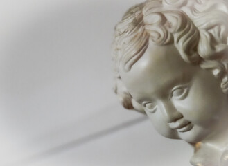 white angel cherub baby face made of stone with focus on eyes