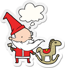 cartoon santa making toy and thought bubble as a printed sticker