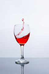Beautifully pour red wine into a glass