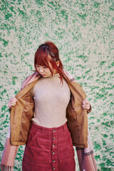 Fototapeta premium vertical portrait of a young asian woman opening her jacket