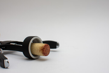 Corkscrew with a cork from an open bottle of red wine