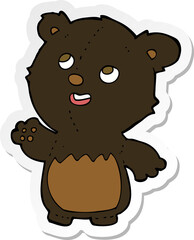 sticker of a cartoon happy little teddy black bear