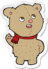 sticker of a cartoon cute teddy bear with scarf