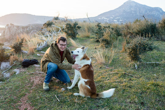 Person and husky in mountains