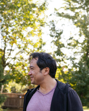 Smiling man outside in nature park.