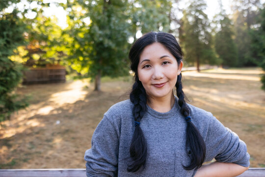 Happy, natural woman portrait in park.