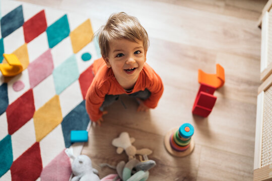 Portrait of Happy Toddler Playing With Toys
