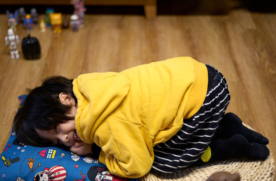 Asian little boy lying on the floor at home