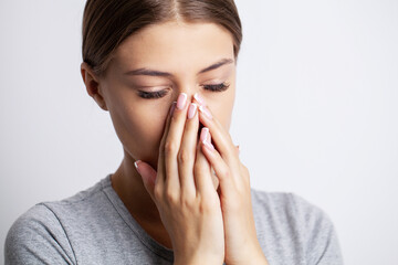 A young woman is sick and has a runny nose