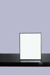 Black Empty Frame mockup on black table with Purple background