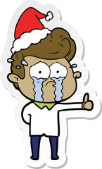 Fototapeta premium sticker cartoon of a crying man wearing santa hat