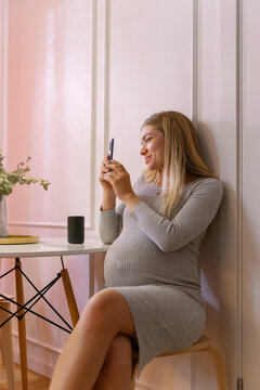 Portrait Of Cheerful Pregnant Woman Taking A Photo