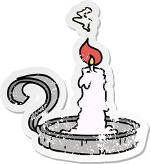 distressed sticker cartoon doodle of a candle holder and lit candle