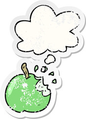 cartoon bitten apple and thought bubble as a distressed worn sticker