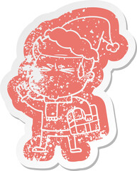 cartoon distressed sticker of a man sweating wearing santa hat