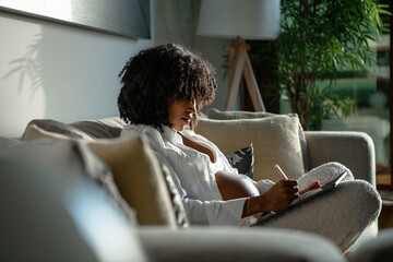 Pregnant woman on couch at home