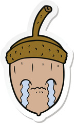sticker of a cartoon crying acorn