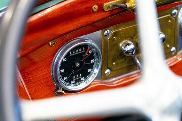 Oldtimer car wood-covered dashboard with odometer