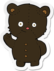 sticker of a cartoon waving black bear cub