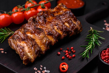 Delicious grilled pork ribs with sauce, spices and herbs