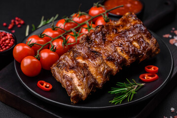 Delicious grilled pork ribs with sauce, spices and herbs
