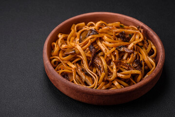 Delicious noodles or udon with mushrooms, salt, spices and herbs