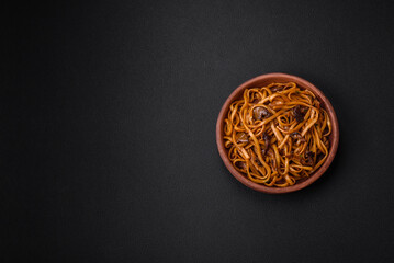 Delicious noodles or udon with mushrooms, salt, spices and herbs