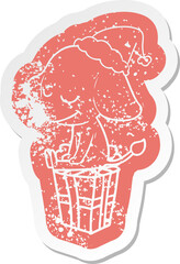 cartoon distressed sticker of a smiling elephant wearing santa hat