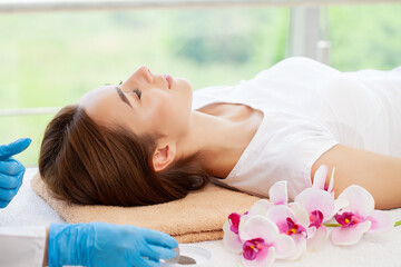 Fototapeta na wymiar Young woman getting spa massage treatment at beauty spa salon