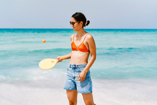 Woman playing with frescobol paddle
