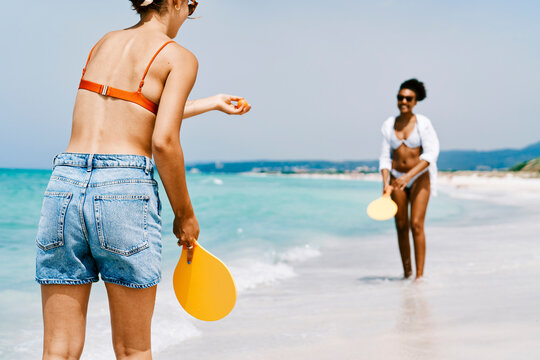 Young friends playing ping pong on beach