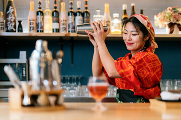 Japanese barkeeper preparing cocktail in club