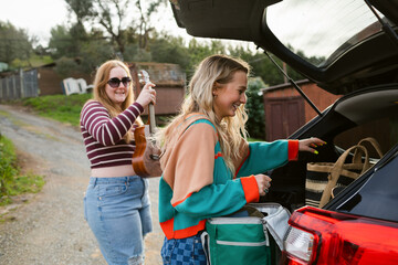 Friends preparing luggage for epic road trip