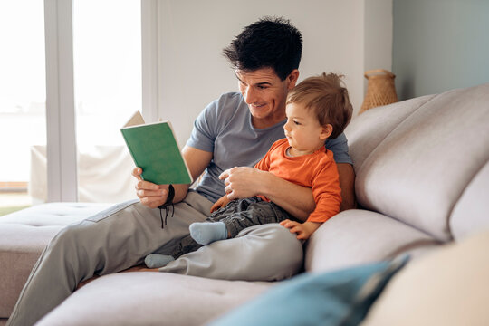 Dad teaching his son how to read