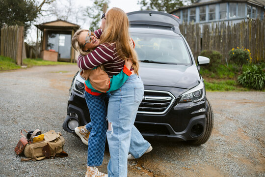 Best friends hugging outdoor on road trip