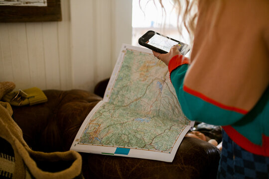 Female taking photo to travel route guide map