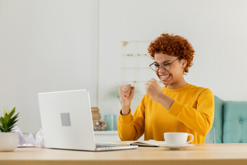 Excited happy african american woman euphoric winner. Girl student looking at laptop passed exam...