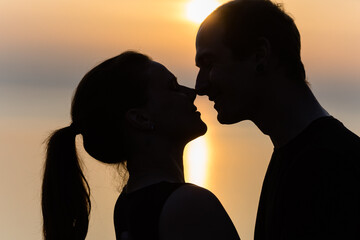 Silhouettes of kissing man and woman