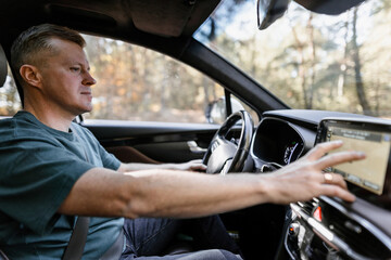 A man uses a display while driving a car