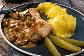 Grilled chicken breast with mushroom sauce.