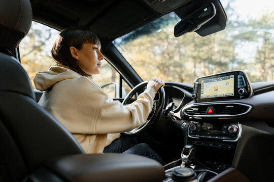 Woman using navigator while driving a car